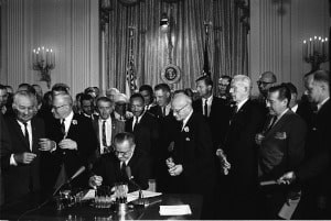 Photo of United States President Lyndon B. Johnson signing the Civil Rights Act.