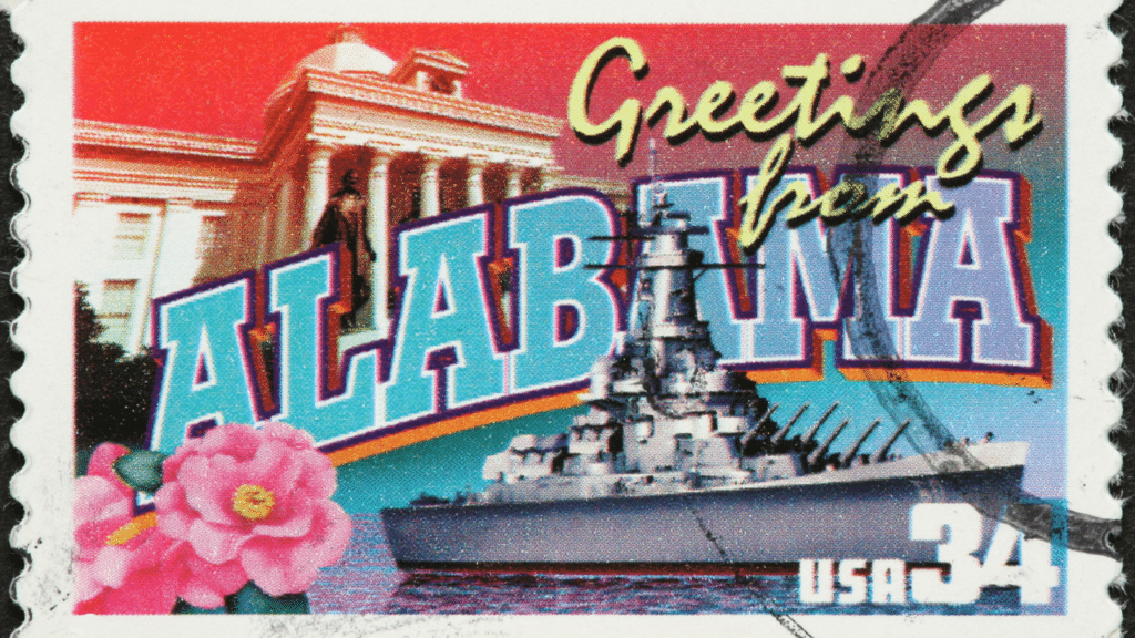 A postcard featuring a ship and building, showcasing Alabama.