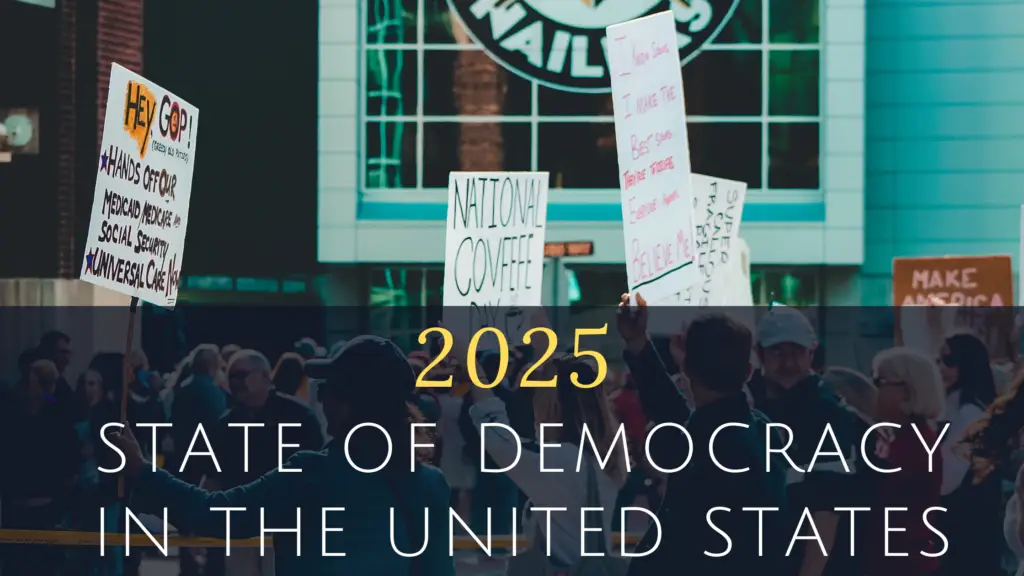 Protesters holding signs in front of a building emphasize the 2025 State of Democracy in the United States.