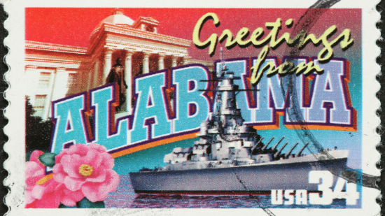 A postcard featuring a ship and building, showcasing Alabama.